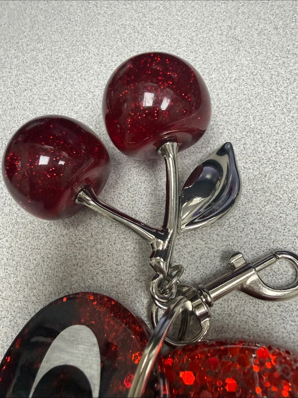 COACH Gunmetal Leather Tag with Red Glitter Cherry Keyring